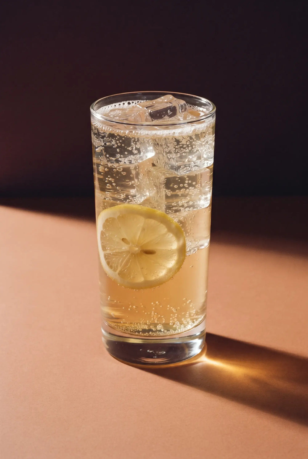 The Kinn Spritz: a tall highball of Kinn over ice with a lemon wheel down the side
