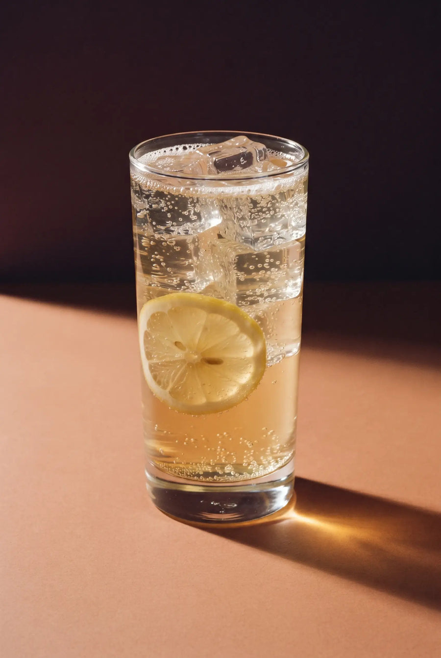 The Kinn Spritz: a tall highball of Kinn over ice with a lemon wheel down the side