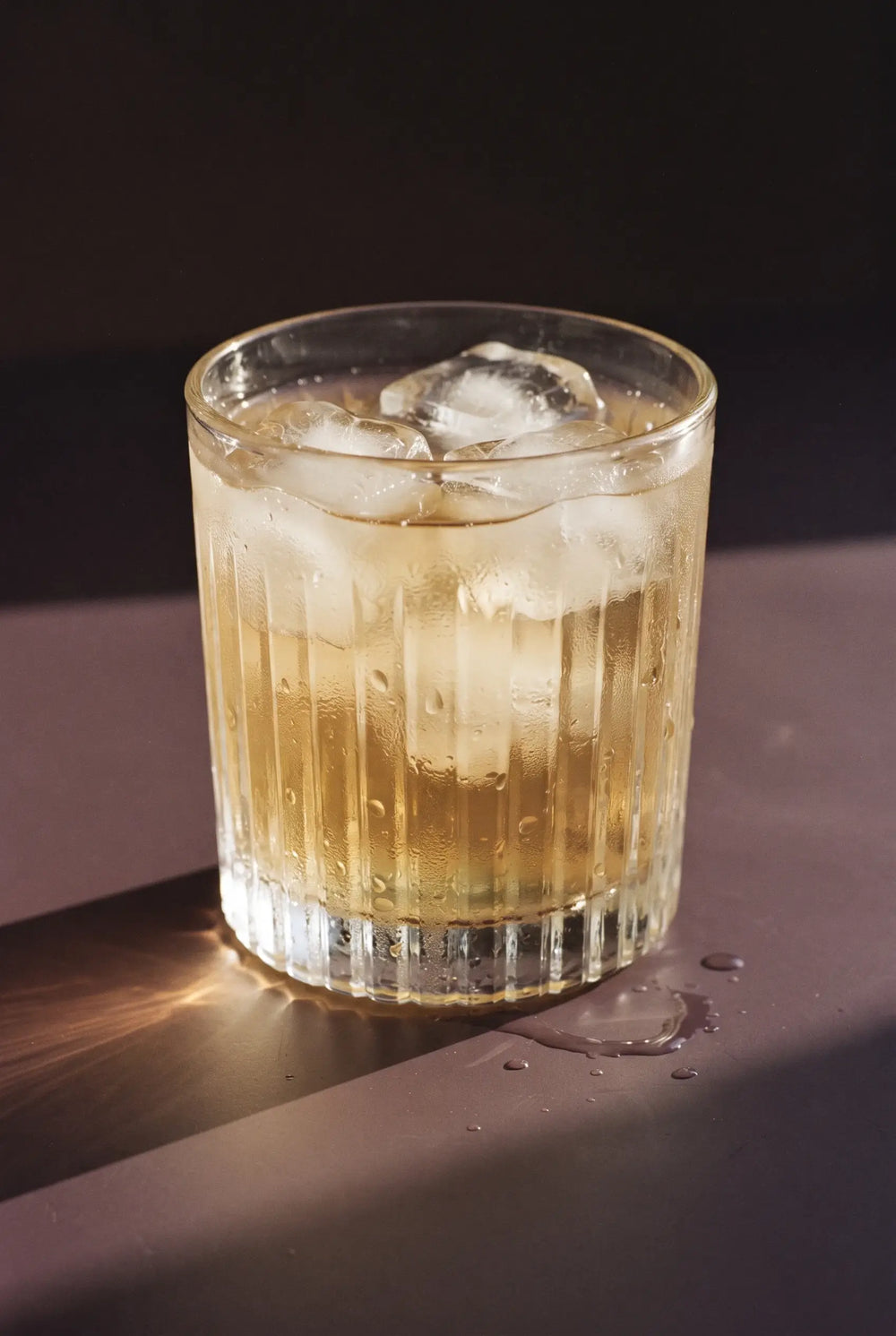 Kinn on the Rocks: a short ribbed tumbler of Kinn over ice with nothing added